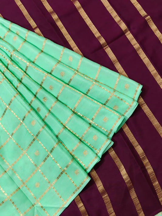 Pista green colour Mysore crepe silk saree with zari checks & ganda berunda motif all over