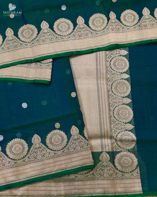 peacock green colour organza saree with zari butta all over